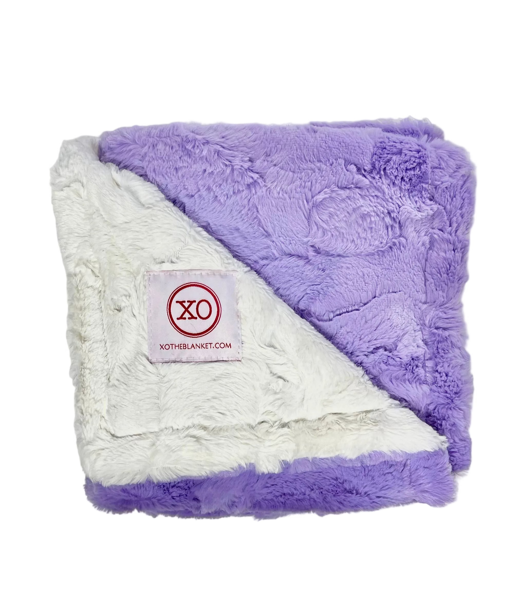 A folded plush throw blanket with a diagonal split of lavender purple and white sherpa-like fabric